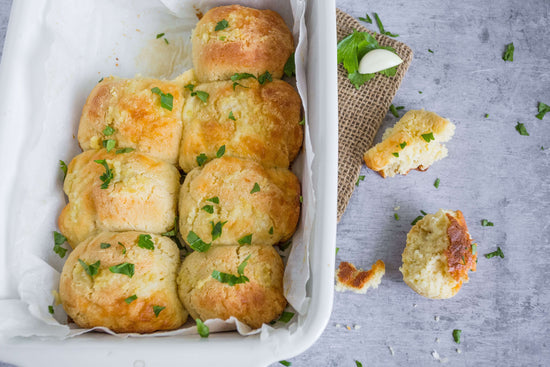 A white baking dish of baked biscuits.