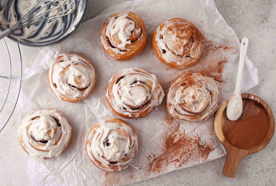Cinnamon rolls with creamy icing sprinkled with extra cinnamon. 