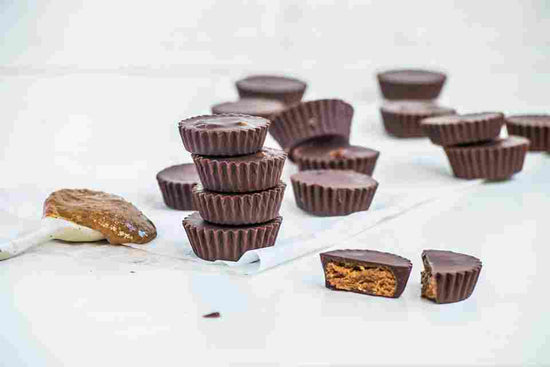 Almond Butter Cupcakes on a white covered surface.